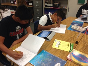 Students work together on an assignment on an iPad